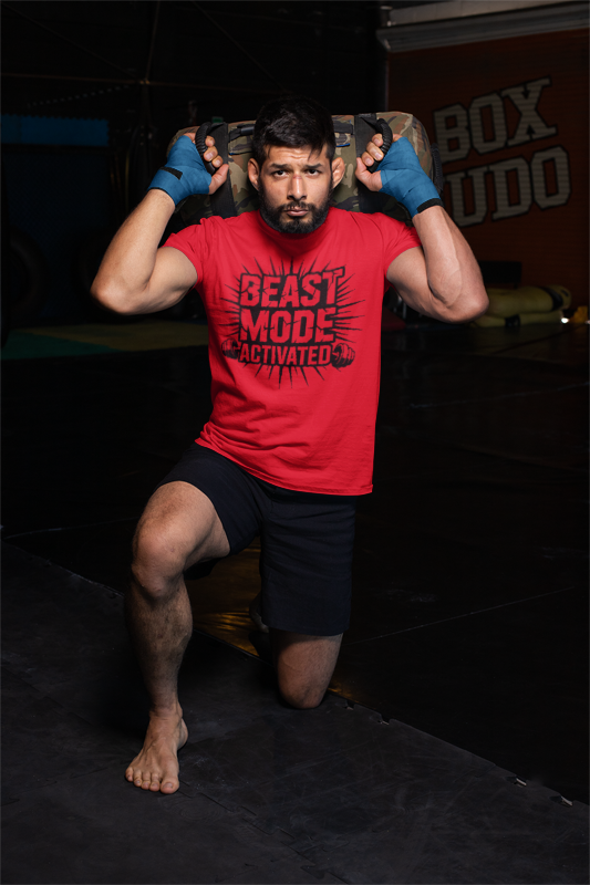 Person wearing a red 'Beast Mode Activated' t-shirt in a dark room with 'Box Udo' branding. Beast Mode Activated Tee — Motivational Gym Workout T-Shirt