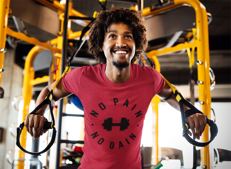 Man in a gym wearing a red 'No Pain, No Gain' t-shirt. No Pain No Gain Dumbbell Gym Tee — Workout Fitness Motivational T-Shirt